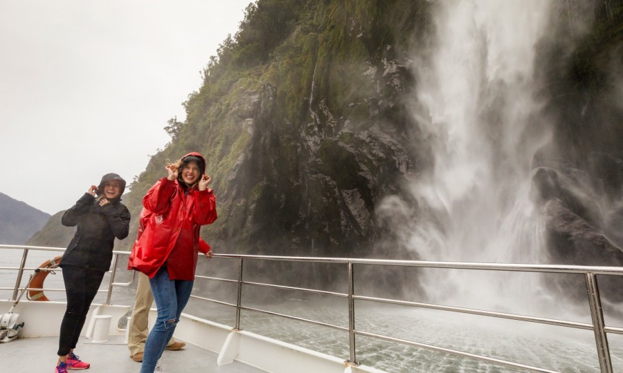 Milford Sound Nature cruise getting sprayed by a waterfall